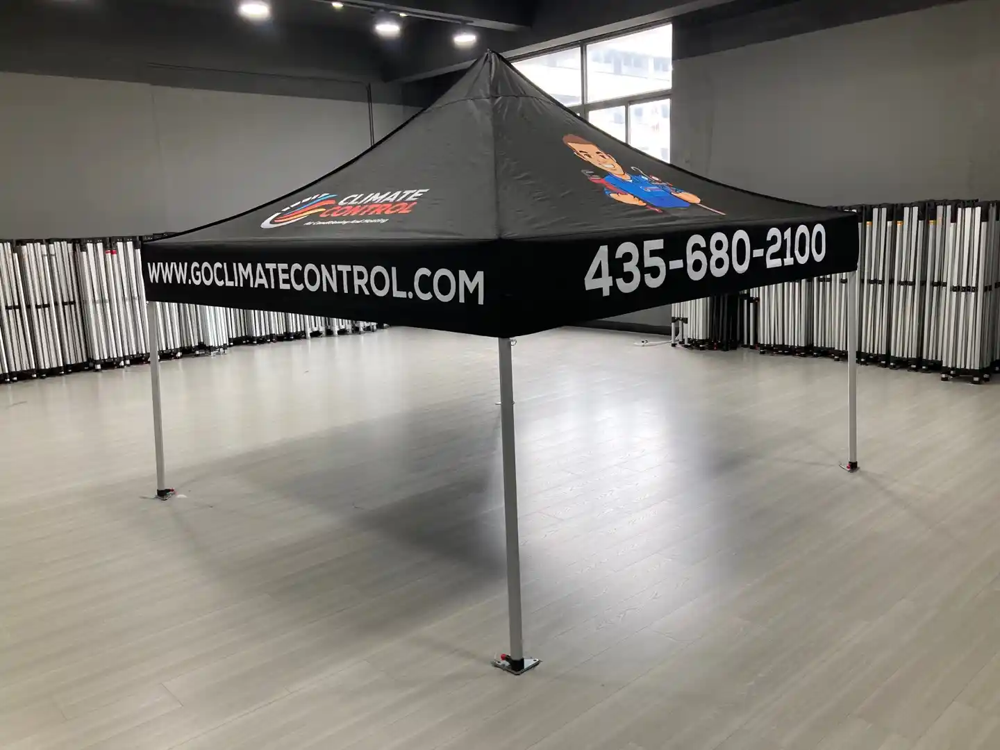 Custom 10x20 Track & Field tent with red hawk shield logo on a black canopy